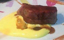 Roast pork neck with caramelized Bassano red onions, saffron potato foam and glaze